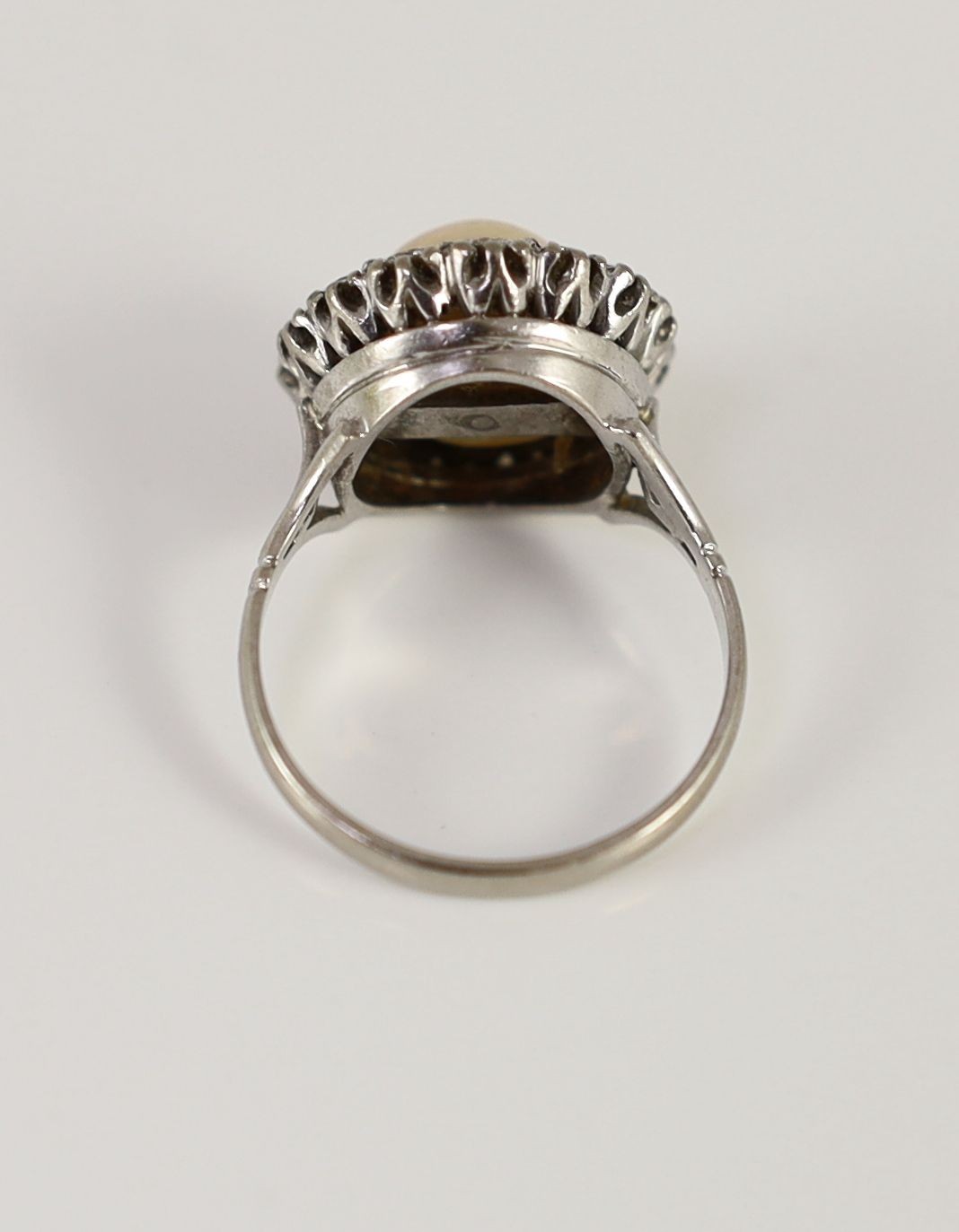 A mid 20th century platinum?, split pearl and diamond set circular cluster ring